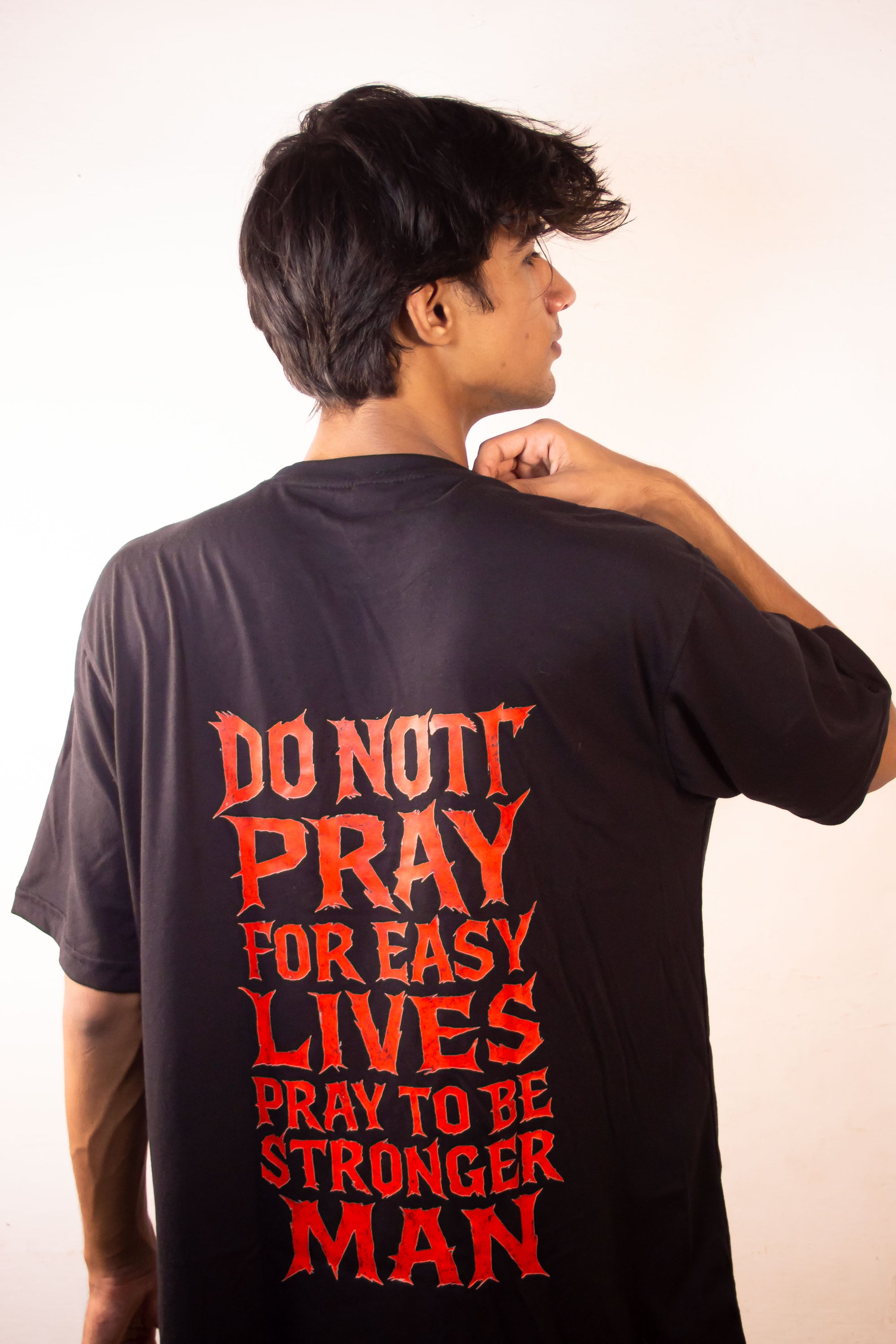 Men’s Tee Featuring the Quote – “Don’t Pray for Easy Lives, Pray to Be Stronger Men”
