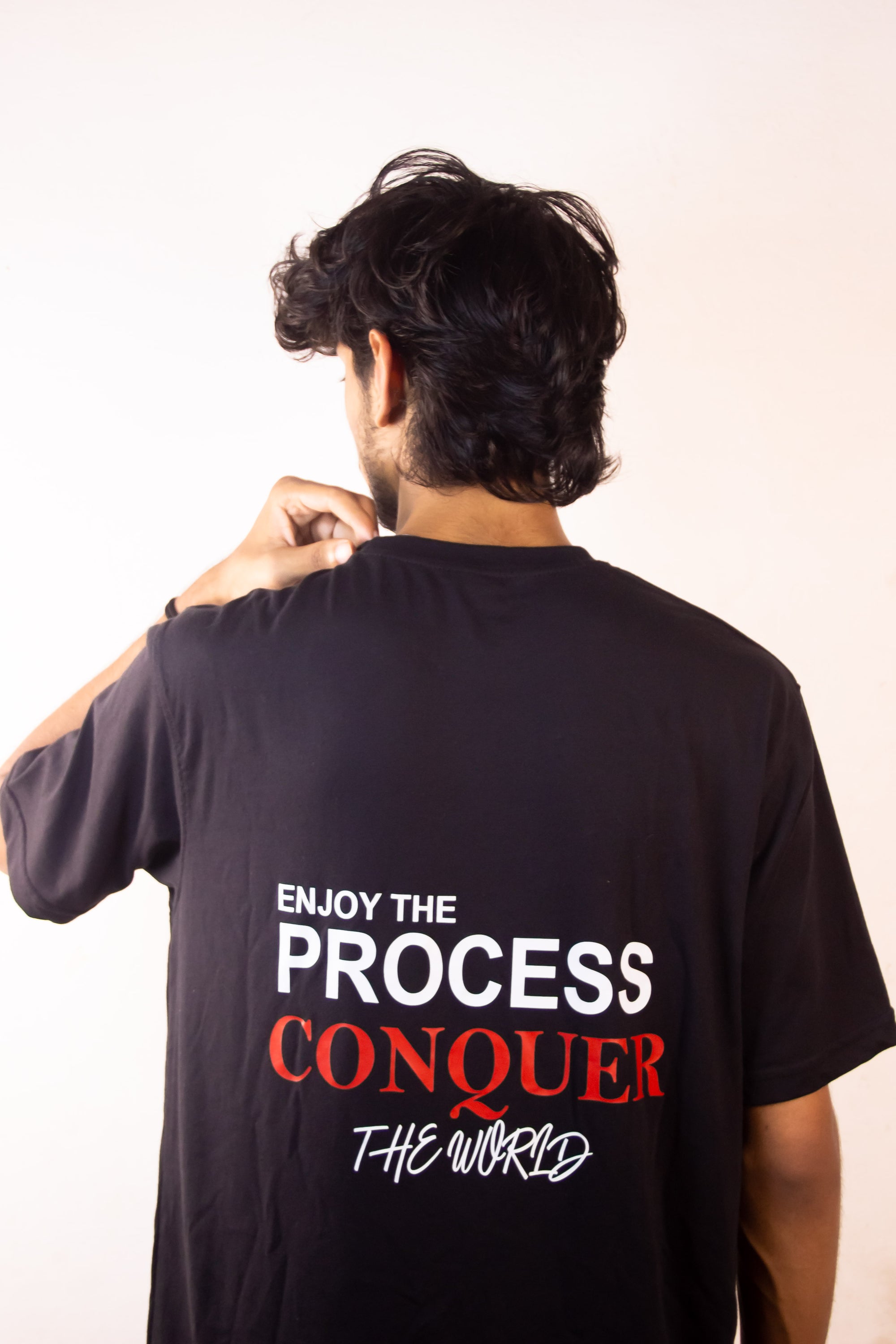 Men’s Tee Featuring the Quote – “Enjoy the Process, Conquer the World”